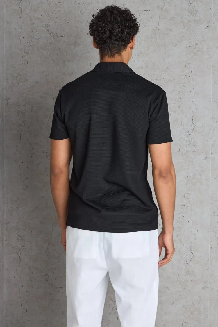 Polo basic noir texturé